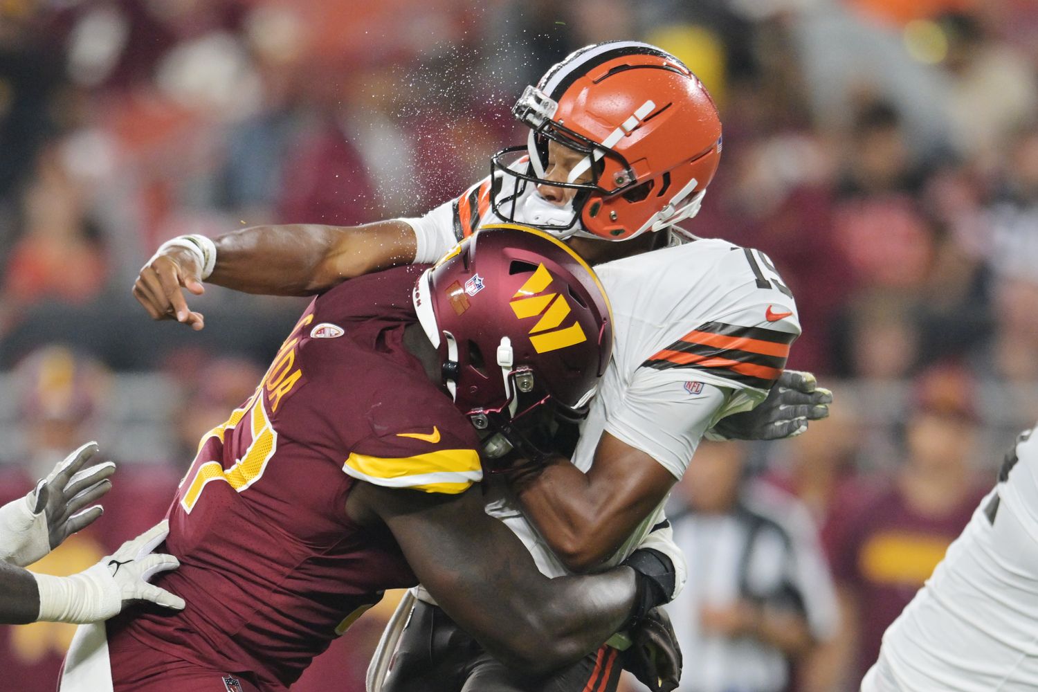 Washington Commanders defensive end Efe Obada (97) hits Cleveland Browns quarterback Joshua Dobbs (15) during the first half at Cleveland Browns Stadium.